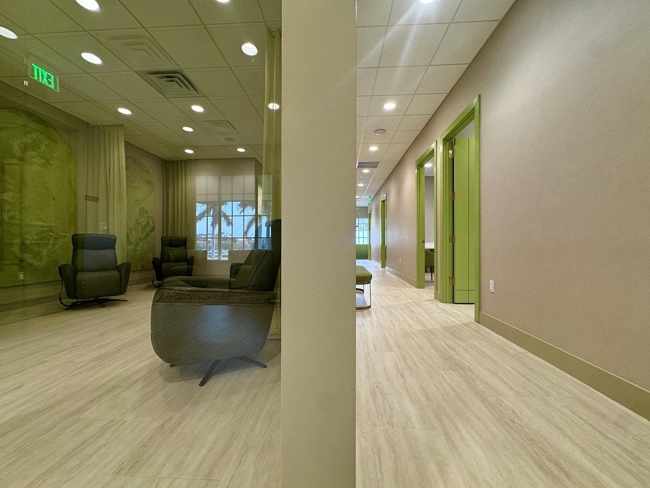 A sunlit corridor connecting the treatment suites.