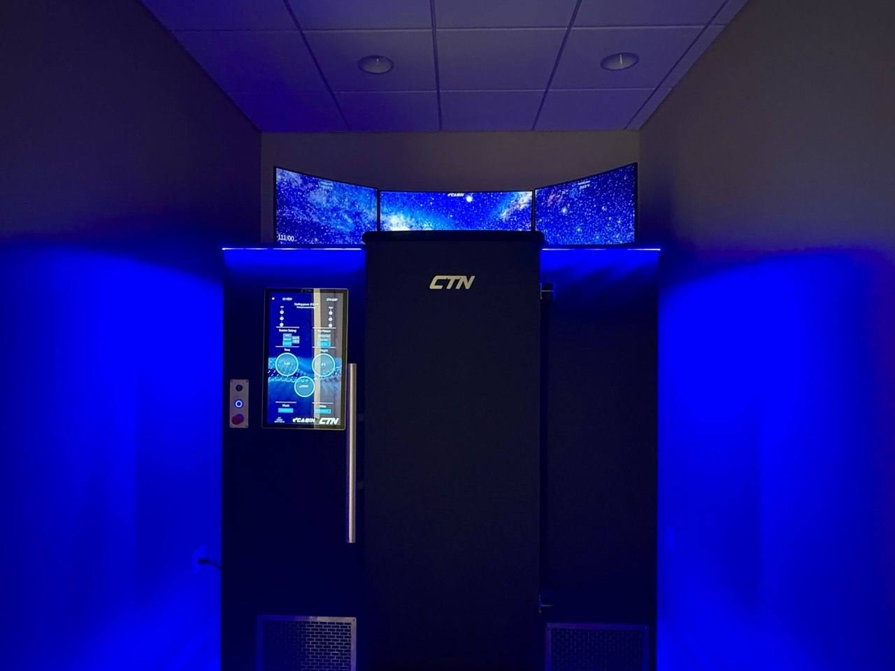 The whole-body cryotherapy cabin glowing in cool blue.